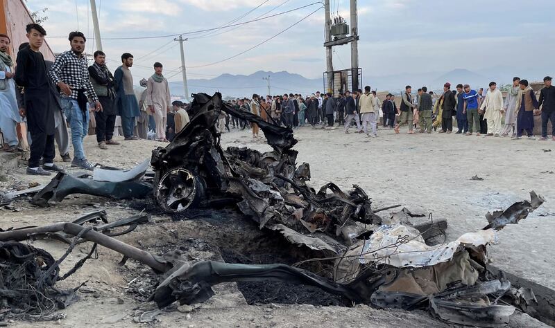 People stand at the site of a blast outside a school in Kabul, Afghanistan on May 8, 2021. Reuters