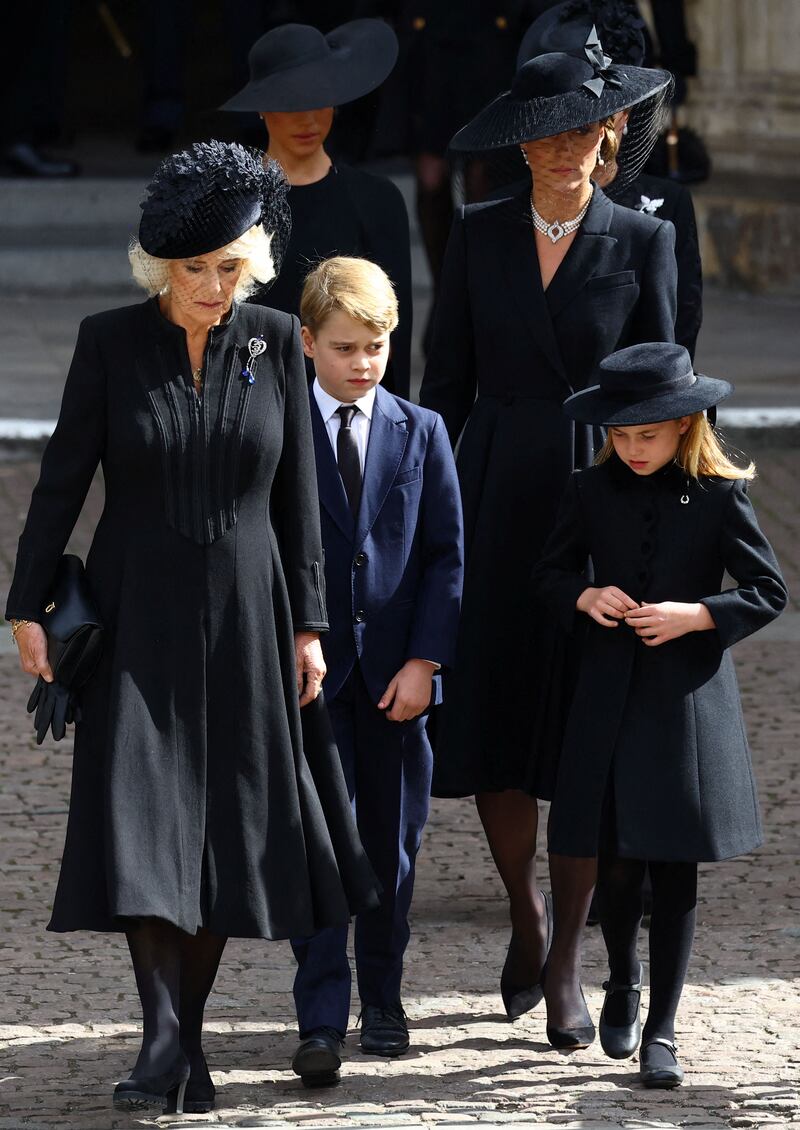 Camilla, the Queen Consort; Catherine, Princess of Wales; Meghan, Duchess of Sussex, Prince George and Princess Charlotte leave the funeral of Queen Elizabeth II. AFP