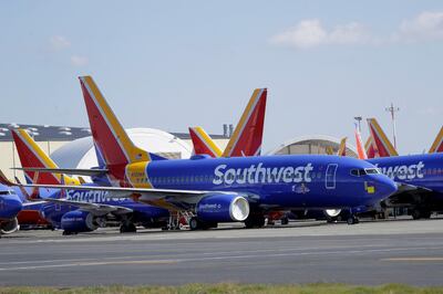 Southwest Airlines airplanes sit parked Tuesday, April 7, 2020, at Paine Field airport in Everett, Wash. A steep decline in travel due to the outbreak of the coronavirus has pushed airlines to cancel flights, run fewer planes and seek government aid. (AP Photo/Ted S. Warren)