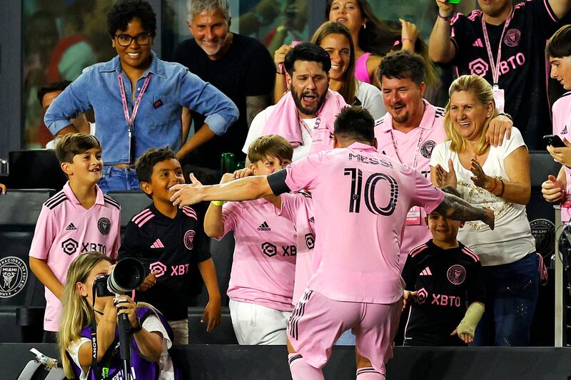 Lionel Messi celebrates his goal with family. AFP