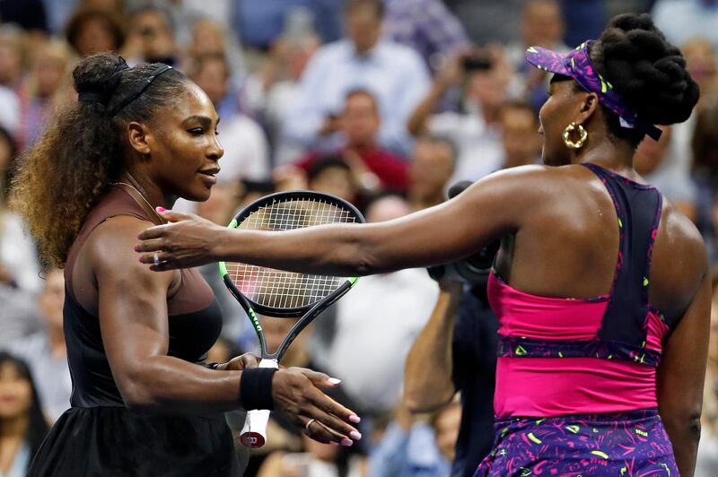 Serena Williams, left, meets her sister Venus Williams after their match during the third round of the U.S. Open tennis tournament, Friday, Aug. 31, 2018, in New York. Serena Williams won 6-1, 6-2. (AP Photo/Adam Hunger)
