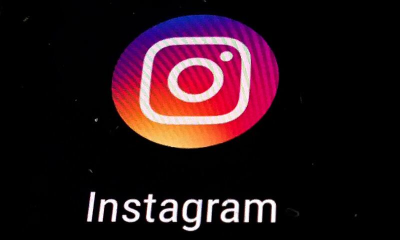 FILE - In this Nov. 29, 2018 file photo, the Instagram app logo is displayed on a mobile screen in Los Angeles. Though Black Out Tuesday was originally organized by the music community, the social media world went dark on Tuesday in support of the Black Lives Matter movement and the many killings of black people around the world that has caused outrage and protests. Instagram accounts, from top record label to everyday people, was full of black squares posted in response to the deaths of George Floyd, Ahmaud Arbery and Breonna Taylor. (AP Photo/Damian Dovarganes, File)