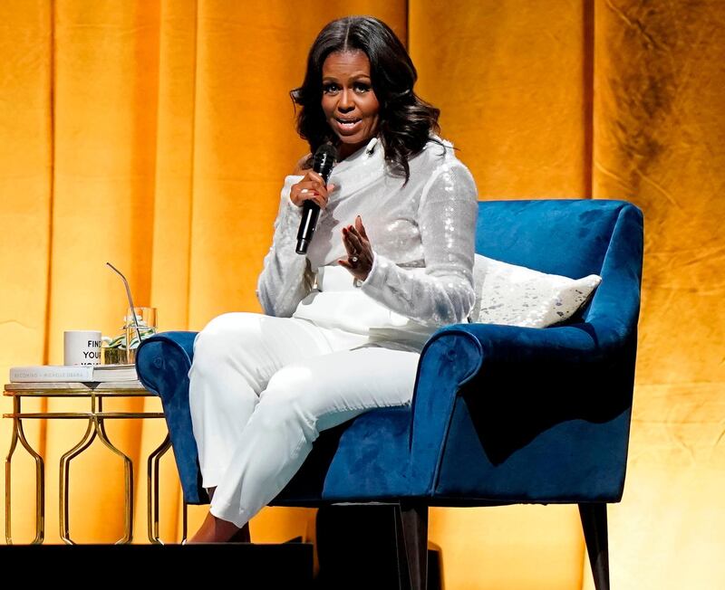 (FILES) In this file photo taken on November 13, 2018, Former US first lady Michelle Obama speaks at the opening of her multi-city book tour at the United Center in Chicago, Illinois.   Former first lady Michelle Obama added her voice on July 19, 2019 to the Democratic outcry following President Donald Trump's attack on four ethnic minority congresswomen, saying "there's a place for all of us." / AFP / JIM YOUNG
