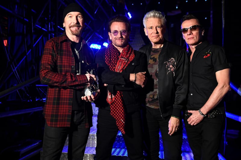 LONDON, ENGLAND - NOVEMBER 12:  (L-R) The Edge, Bono, Adam Clayton and Larry Mullen Jr of U2 pose with the Global Icon award during the MTV EMAs 2017 held at The SSE Arena, Wembley on November 12, 2017 in London, England.  (Photo by Ian Gavan/Getty Images for MTV)