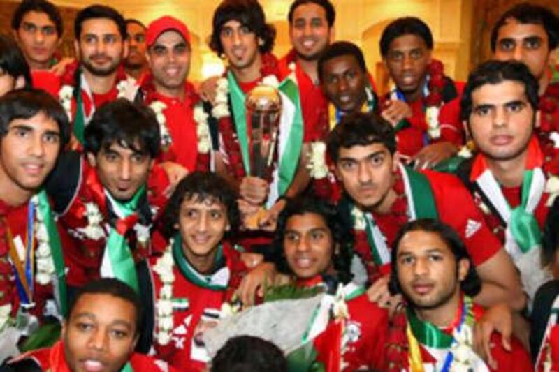 The UAE Under-19s football team show off their trophy on returning home last night as Asian Football Confederation champions. Hamdan al Kamali, holding the trophy, captained his side to a 2-1 victory over Uzbekistan in Saudi Arabia on Friday to clinch the title.