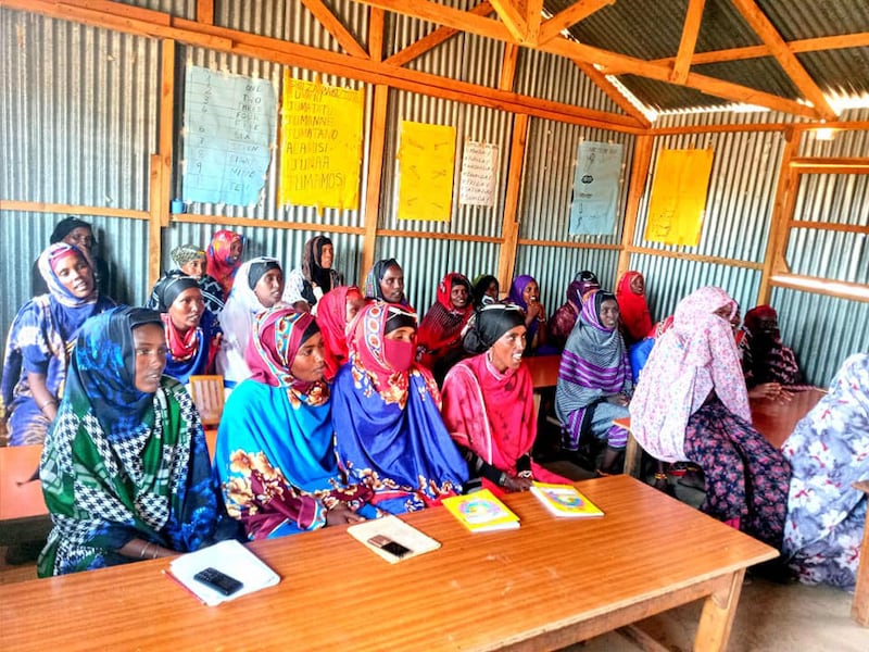 A group of women learning to read and write.