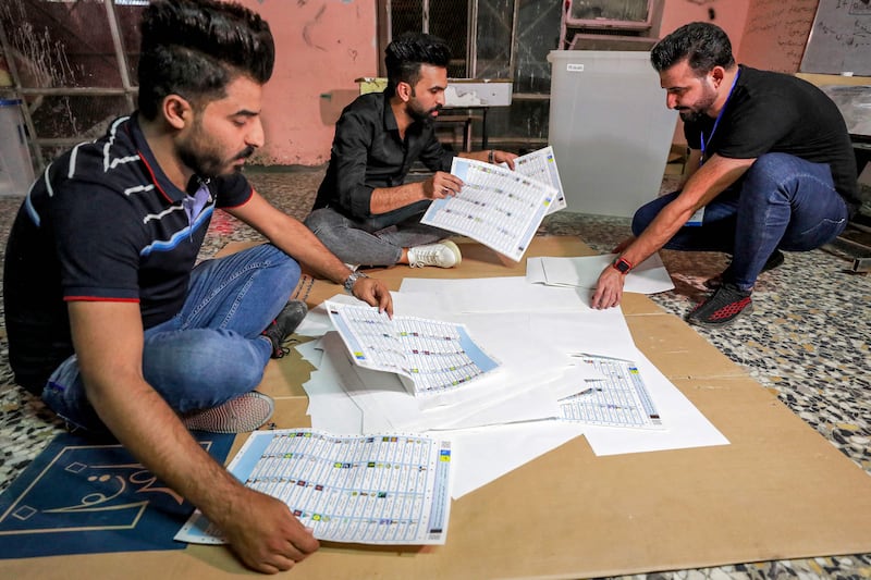 Iraqi election officials count votes at a polling station in  Baghdad. AFP
