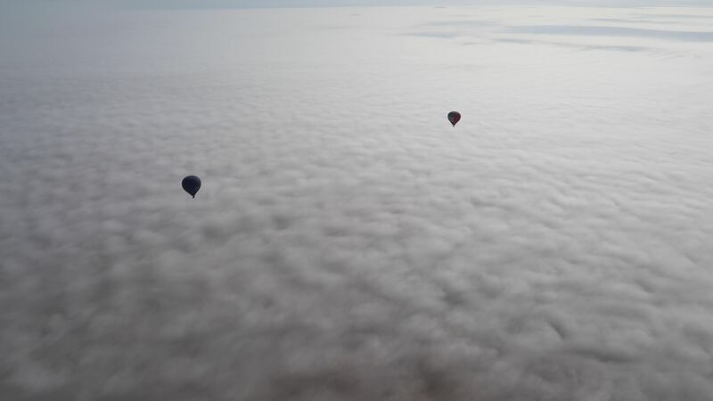 Balloons in a sea of fog. Andy Scott / The National