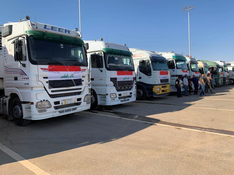 Iraqi trucks wait to cross into Saudi. Reuters