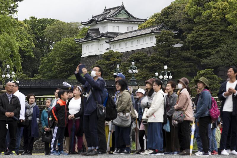 People visit the outer garden at the Imperial Palace in Tokyo on the day of Emperor Akihito's abdication. Getty
