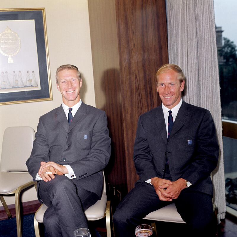 England's Charlton brothers, Jack (l) and Bobby (r), relax at a pre-tournament function. PA