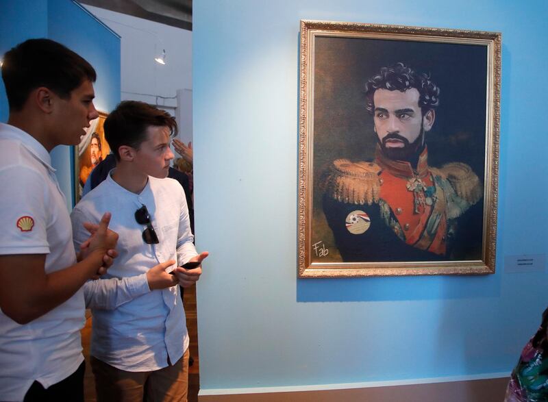 Visitors examine a portrait of Egypt's Mohamed Salah at the Museum of Academy of Arts in St.Petersburg, Russia. Dmitri Lovetsky / AP Photo