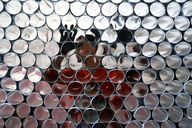 A man arranges metal tubes that are part of a Sobia, a diesel heater, prior to winter season in Sidon, south Lebanon on October 25, 2014. Ali Hashisho / Reuters