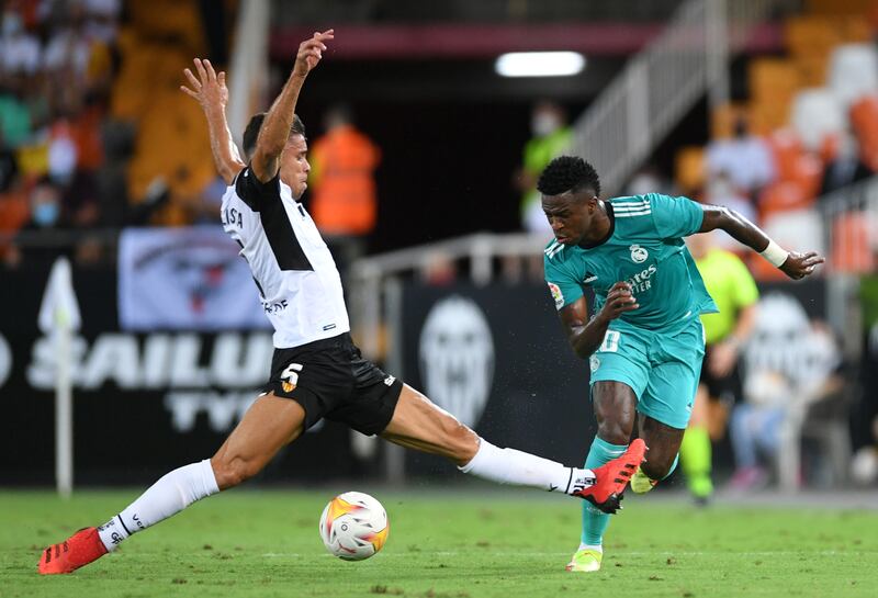 Real Madrid forward Vinicius Junior is challenged by Gabriel Paulista. Getty Images