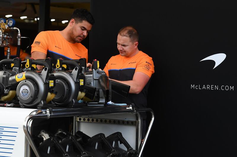 Members of the McLaren team work in pit lane at the Albert Park circuit ahead of the Formula One Australian Grand Prix in Melbourne.  AFP