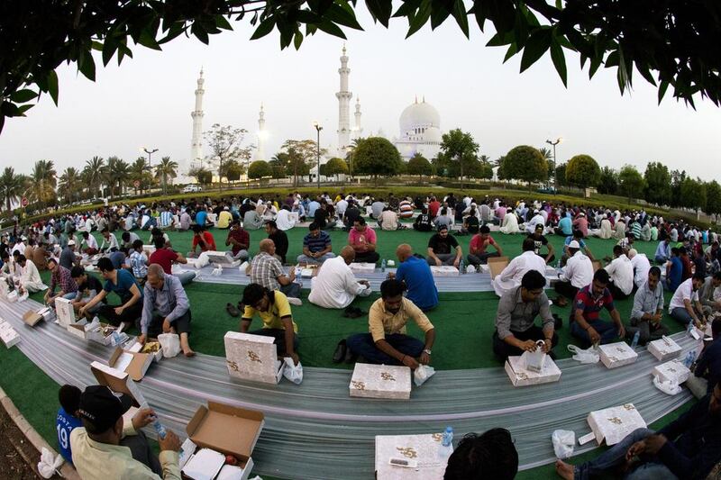 People observing Ramadan wait to break the day’s fast outside the Sheikh Zayed Grand Mosque last year. Even social media activity changes during the holy month. Christopher Pike / The National