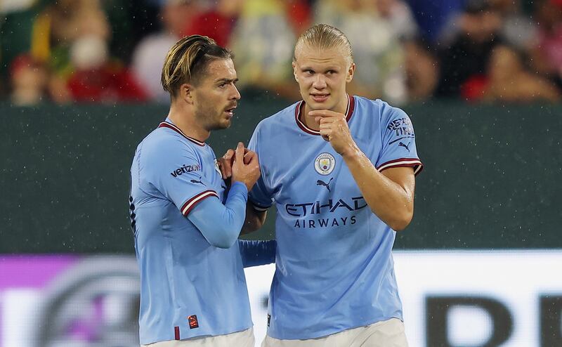 Erling Haaland celebrates with Jack Grealish after scoring Manchester City's first goal. AFP
