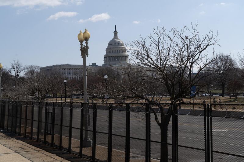 The US Capitol building seen behind barbed wire fences. Willy Lowry / The National
