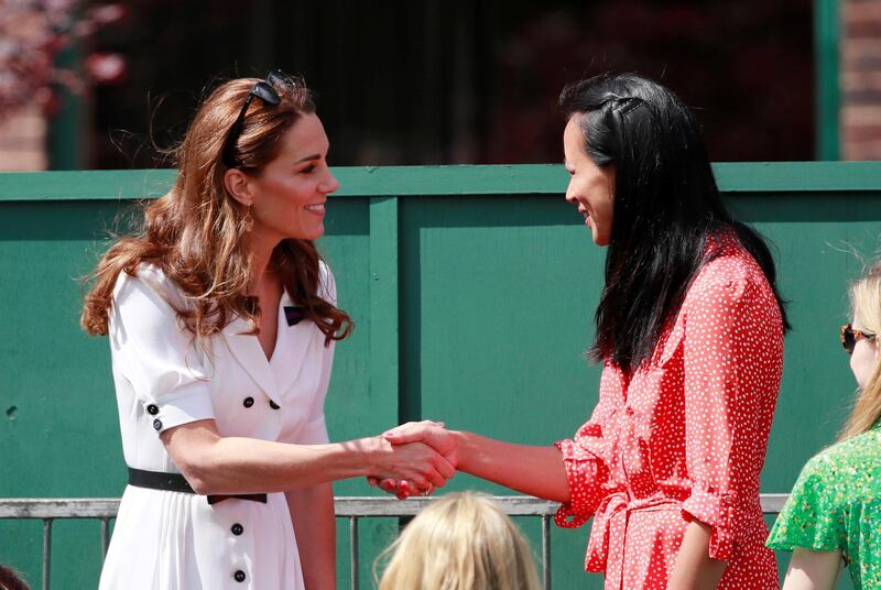 Kate Middleton, Duchess of Cambridge, shakes hands with former British tennis player Anne Keothavong. Reuters