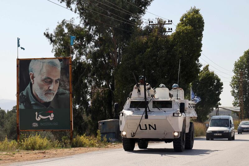 An armoured personnel carrier belonging to the Unifil drives past a poster of Qassem Suleimani, slain commander of Iran's Islamic Revolutionary Guard Corps, in the Marjayoun area of southern Lebanon. AFP