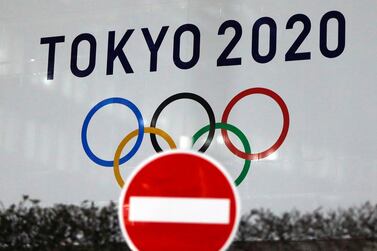 The logo of the  2020 Olympic Games pictured through a traffic sign in Tokyo. Reuters