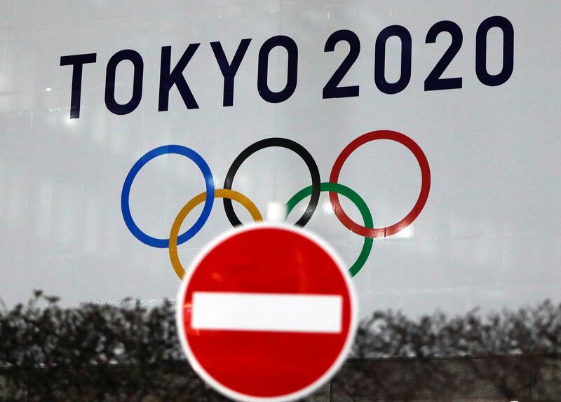 FILE PHOTO: The logo of Tokyo 2020 Olympic Games that have been postponed to 2021 due to the coronavirus disease (COVID-19) outbreak, is seen through a traffic sign at Tokyo Metropolitan Government Office building in Tokyo, Japan January 22, 2021. REUTERS/Issei Kato/File Photo