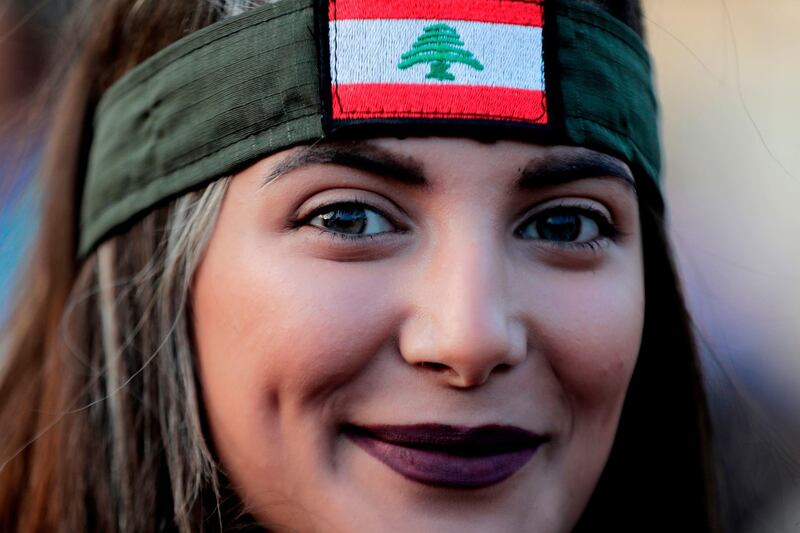 A Lebanese demonstrator looks on during a gathering on the road leading to the Presidential Palace in Baabda, on the eastern outskirts of Beirut on November 13, 2019, nearly a month into an unprecedented anti-graft street movement. Street protests erupted, the night before, after President Michel Aoun defended the role of his allies, the Shiite movement Hezbollah, in Lebanon's government. Protesters responded by cutting off several major roads in and around Beirut, the northern city of Tripoli and the eastern region of Bekaa. / AFP / ANWAR AMRO
