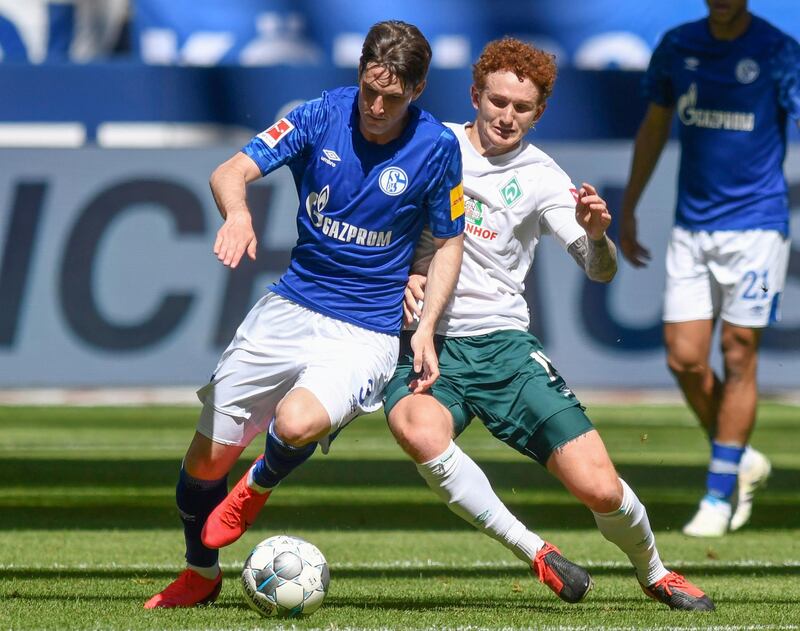 Schalke's Juan Miranda under pressure from Josh Sargent of Bremen. AP