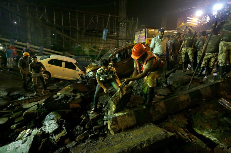 People gather while rescue personnel work at the site. EPA