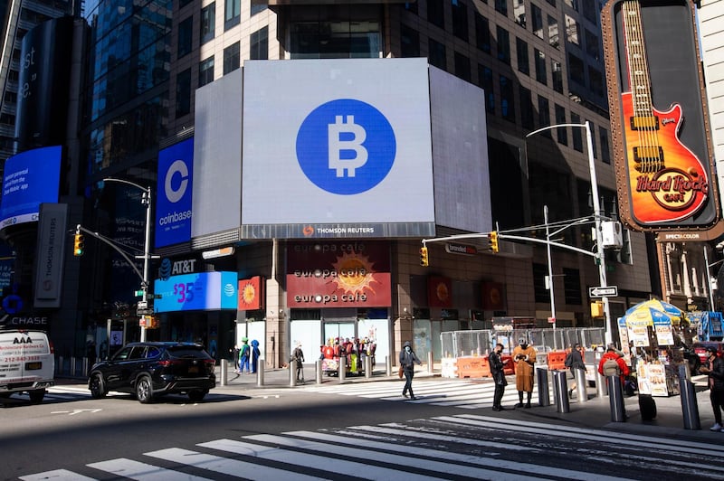 Monitors display Coinbase and Bitcoin signage during the company's initial public offering (IPO) at the Nasdaq MarketSite in New York, U.S., on Wednesday, April 14, 2021. Coinbase Global Inc., the largest U.S. cryptocurrency exchange, is set to debut on Wednesday through a direct listing, an alternative to a traditional initial public offering that has only been deployed a handful of times. Photographer: Michael Nagle/Bloomberg