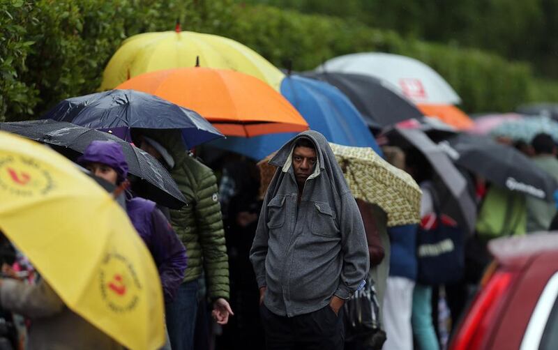 Tennis ans were not deterred by the rain and cold early on Monday morning as they queued for tickets to the Dubai Duty Free Tennis Championships. Satish Kumar / The National 