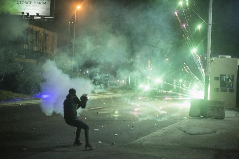 An anti government protester fires fireworks at riot police as they clash during a second day of violence. Getty Images