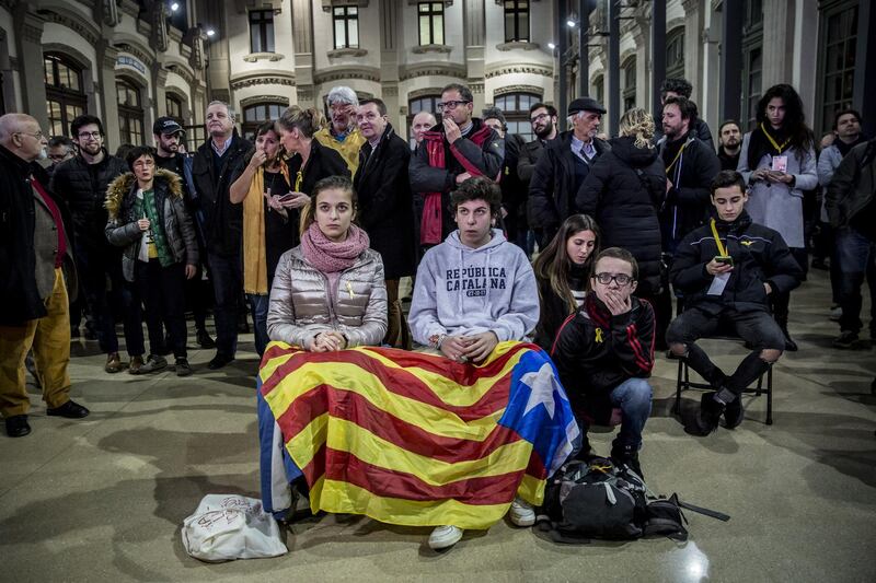 People hold a Catalan flag while following election results at the Esquerra Republicana de Catalunya ERC party headquarters in Barcelona. Angel Garcia / Bloomberg