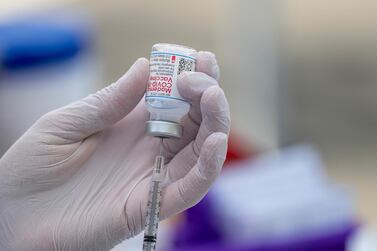 A Moderna Covid-19 vaccine being prepared for use at a site in California. More than 698 million vaccines have been distributed to fight the pandemic, according to Bloomberg's Vaccine Tracker. Bloomberg