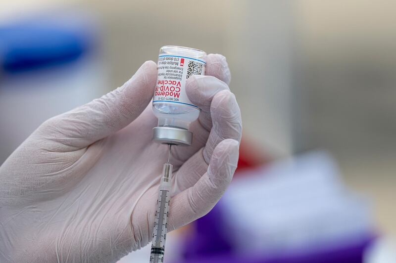 A healthcare worker wearing protective gloves draws a dose of the Moderna Inc. Covid-19 vaccine at a mobile drive-thru vaccination site in Novato, California, U.S., on Wednesday, March 24, 2021. Health departments across the U.S. have deployed mobile units to eliminate challenges like waking up early to schedule appointments, navigating online portals and standing in line, all of which can deter the elderly, disabled or immune-compromised. Photographer: David Paul Morris/Bloomberg