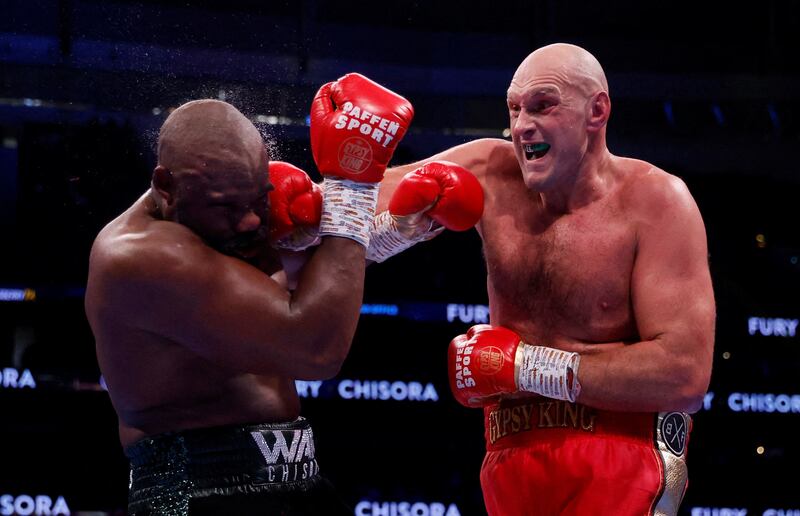 Tyson Fury lands a punch on Derek Chisora during their WBC heavyweight world title fight. Reuters