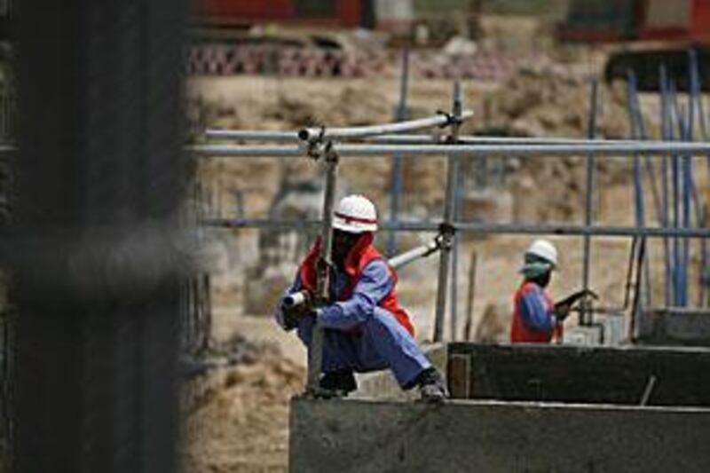 Construction crews work on the foundation of the Masdar Institute in Masdar City on the outskirts of Abu Dhabi.