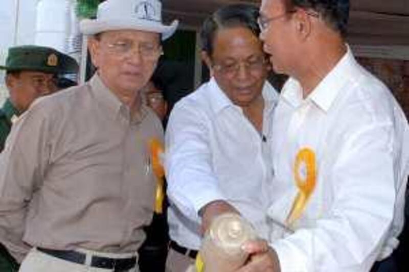 In this Thursday, April 29, 2010, photo Myanmar Prime Minister Gen. Thein Sein, left, inspects a sample of cement produced at Myodaw Cement Plant in Pyinyaung village, in Mandalay, Myanmar. A group closely linked to Myanmar's ruling junta applied to register as a political party Thursday, taking the initial step to participate in elections this year.The Union Solidarity and Development Party,  applied for political party registration with the Election Commission, as did party head Thein Sein and 26 other members, Myanmar state media reported.  (AP Photo) *** Local Caption ***  MYN101_Myanmar_Politics.jpg *** Local Caption ***  MYN101_Myanmar_Politics.jpg