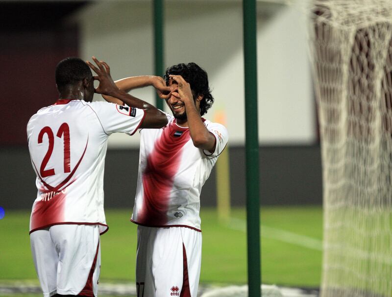 ABU DHABI - UNITED ARAB EMIRATES - 10OCT2012 - AL Wahda's Salem Salah, right and Papa Waigo celebrates behind the net after scoring third goal against Al Shaab during Etisalat Cup match yesterday at Al Wahda club in Abu Dhabi. Ravindranath K / The National 