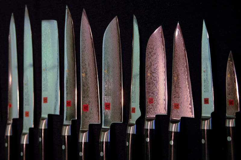 TOPSHOT - This picture taken on September 16, 2022 shows a variety of knives displayed at a factory of Sumikama Cutlery in Seki, Gifu prefecture.  - In a Japanese city once famous for forging samurai swords, craftsmen sharpen and polish kitchen knives, but even at full tilt their small factory can't keep up with global demand.  The export value of knives and other bladed tools like scissors hit a record high in Japan last year, partly thanks to a home-cooking boom sparked by the pandemic.  (Photo by Kazuhiro NOGI  /  AFP)  /  TO GO WITH AFP STORY Japan-lifestyle-culture-craft-knives by Natsuko FUKUE