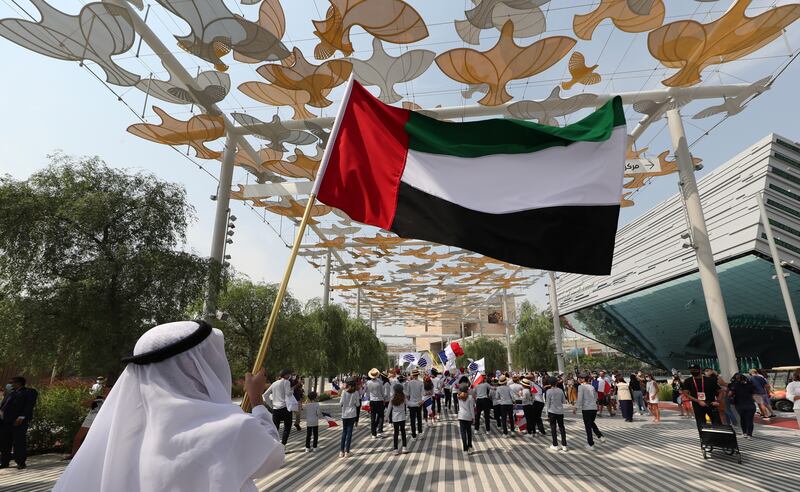 People perform during a parade for the Expo 2020 France Day. Photo: EPA