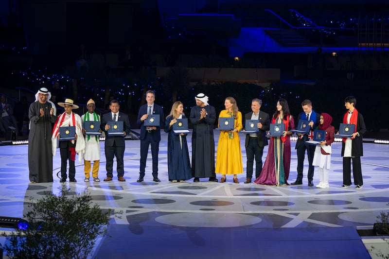 President Sheikh Mohamed and Cop28 President and Minister of Industry and Advanced Technology Dr Sultan Al Jaber stand for a photograph with the Zayed Sustainability Prize winners during Cop28 at Expo City Dubai.