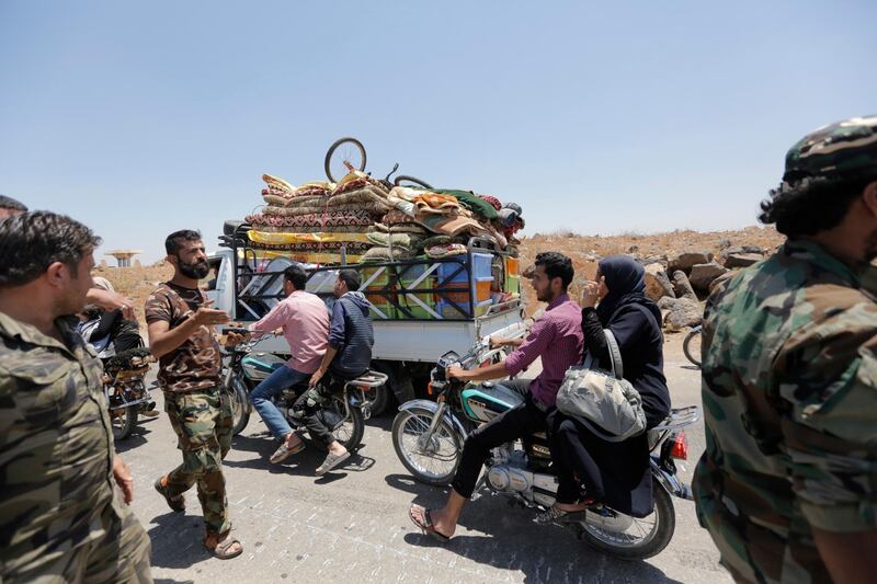 epa06871809 People return to Saida town via Nassib border crossing in the southeastern countryside of Daraa city in south Syria, 07 July 2018. According to media reports, the Syrian army seized control on the crossing on the Syrian-Jordanian borders a day earlier. The crossing has a strategic importance and is considered Syria's southern gate and a main transport and economic hub.  EPA/YOUSSEF BADAWI