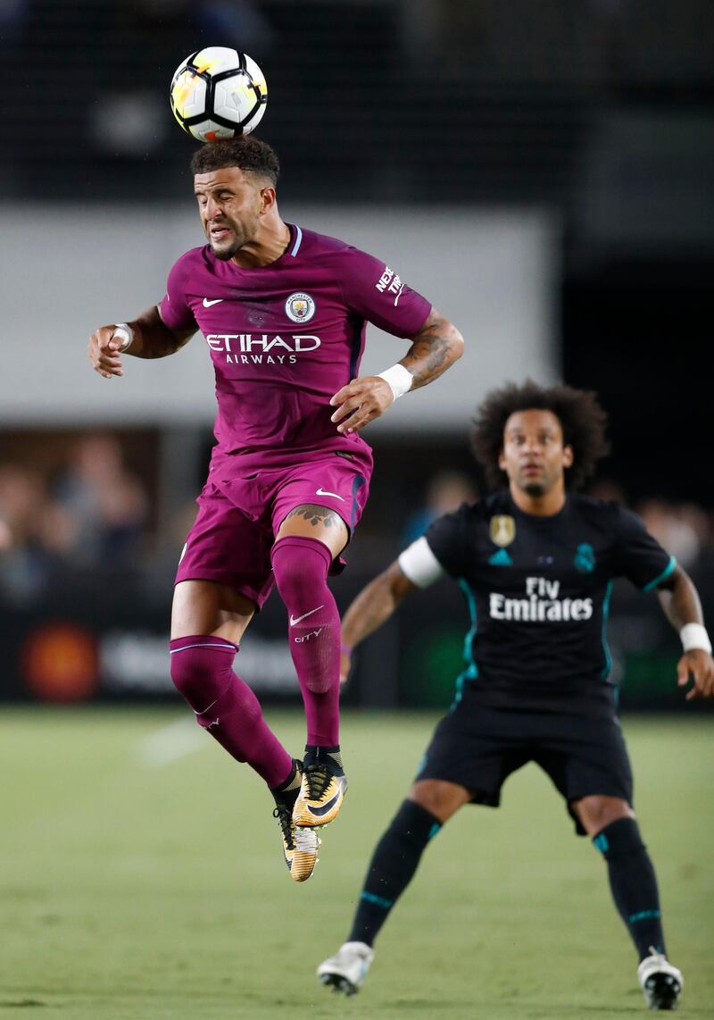 Manchester City's Kyle Walker, left, heads the ball in front of Real Madrid's Marcelo. Paul Buck / EPA