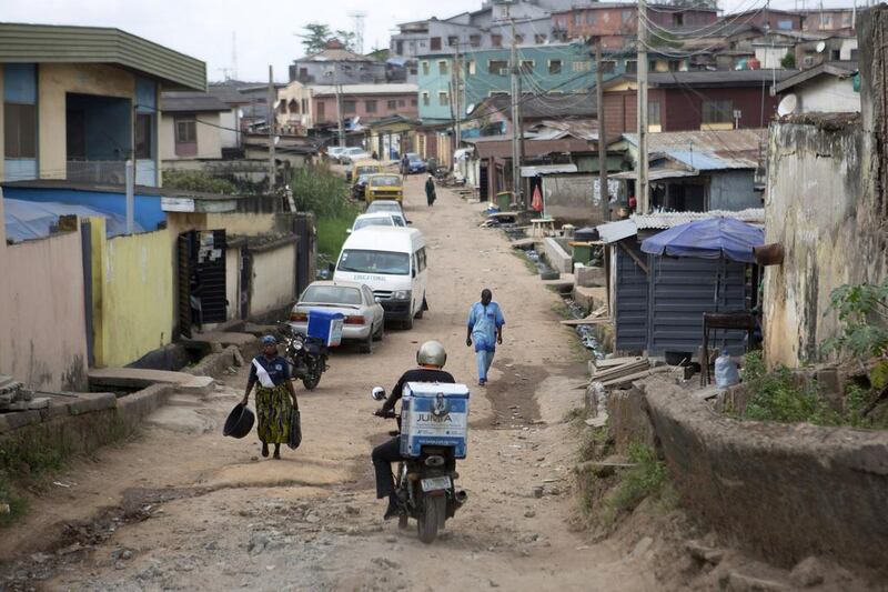 Moses Udoh, an employee of online retailer Jumia, makes a delivery by motorcycle in Lagos. Joe Penney / Reuters