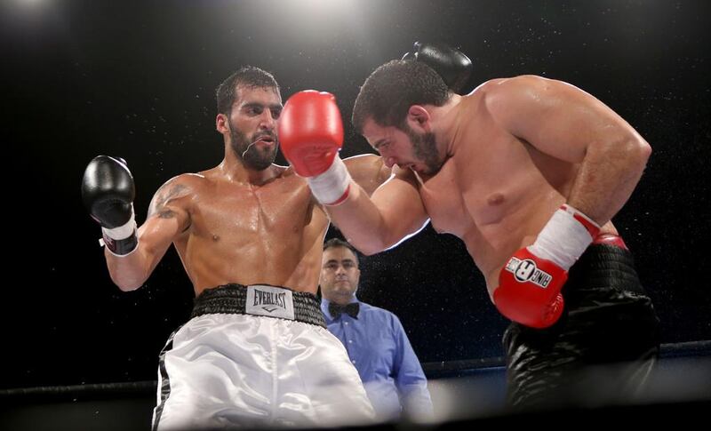Mohammad Ali Bayat Farid v Abdul Kabbani. The Iranian Farid, in black, defeated Kabbani, of Syria, in white, when Kabbani retired in the fourth round. Sammy Dallal / The National