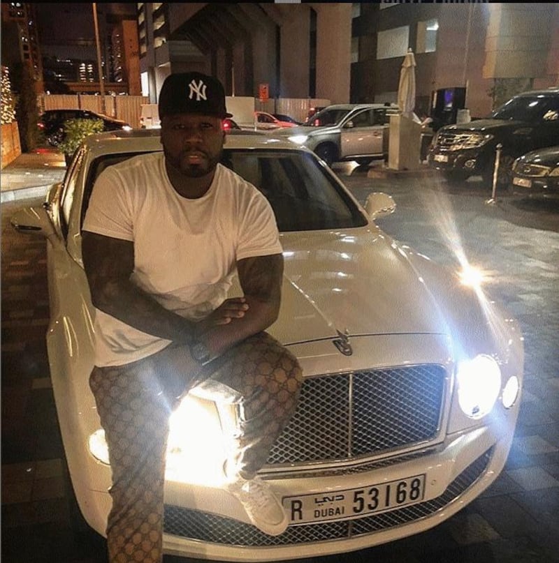 50 Cent posing on a Bentley in a Dubai parking lot, following his performance at Base Dubai on January 18. Instagram / 50 Cent
