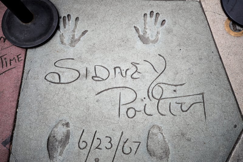The signature and handprints of late US actor Sidney Poitier in front of the Chinese Theatre in Hollywood, California. EPA / ETIENNE LAURENT