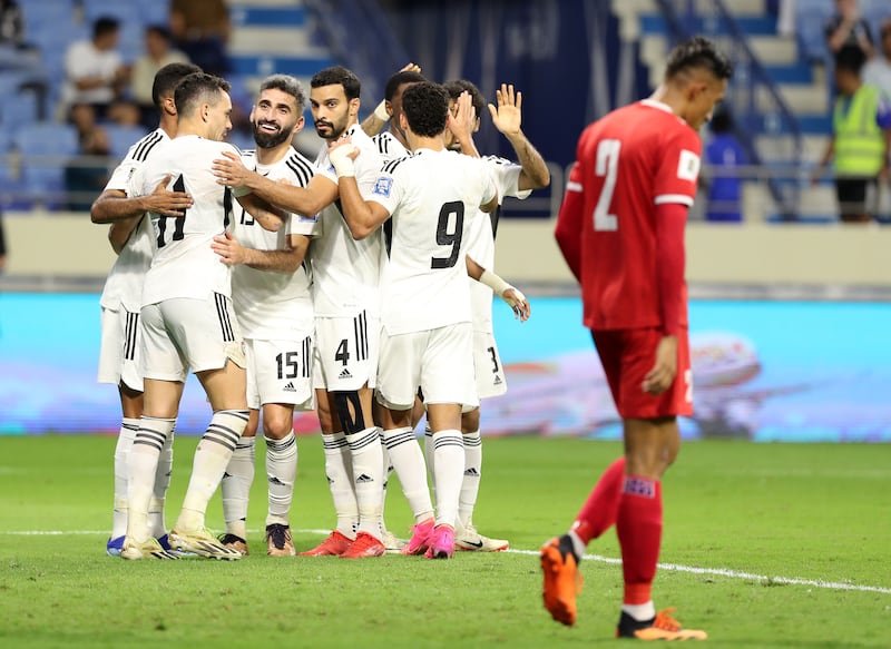 UAE striker Ali Mabkhout celebrates with teammates after scoring his second goal to make it 3-0.