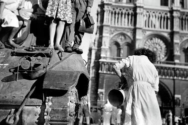 FRANCE - AUGUST 25: World War II. Liberation of Paris on August 25, 1944, 7a.m. in front of the Cathedral of Notre-Dame. On the tank, Michel Frys, who was later wounded by an ambushed German. (Photo by Gaston Paris/Roger Viollet/Getty Images)